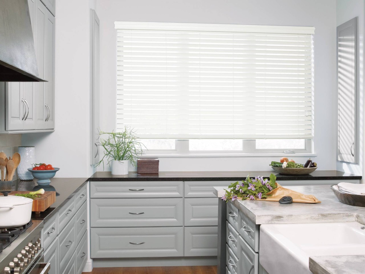 White Hunter Douglas EverWood® Faux Wood Blinds hanging in a large kitchen window near Jupiter, FL