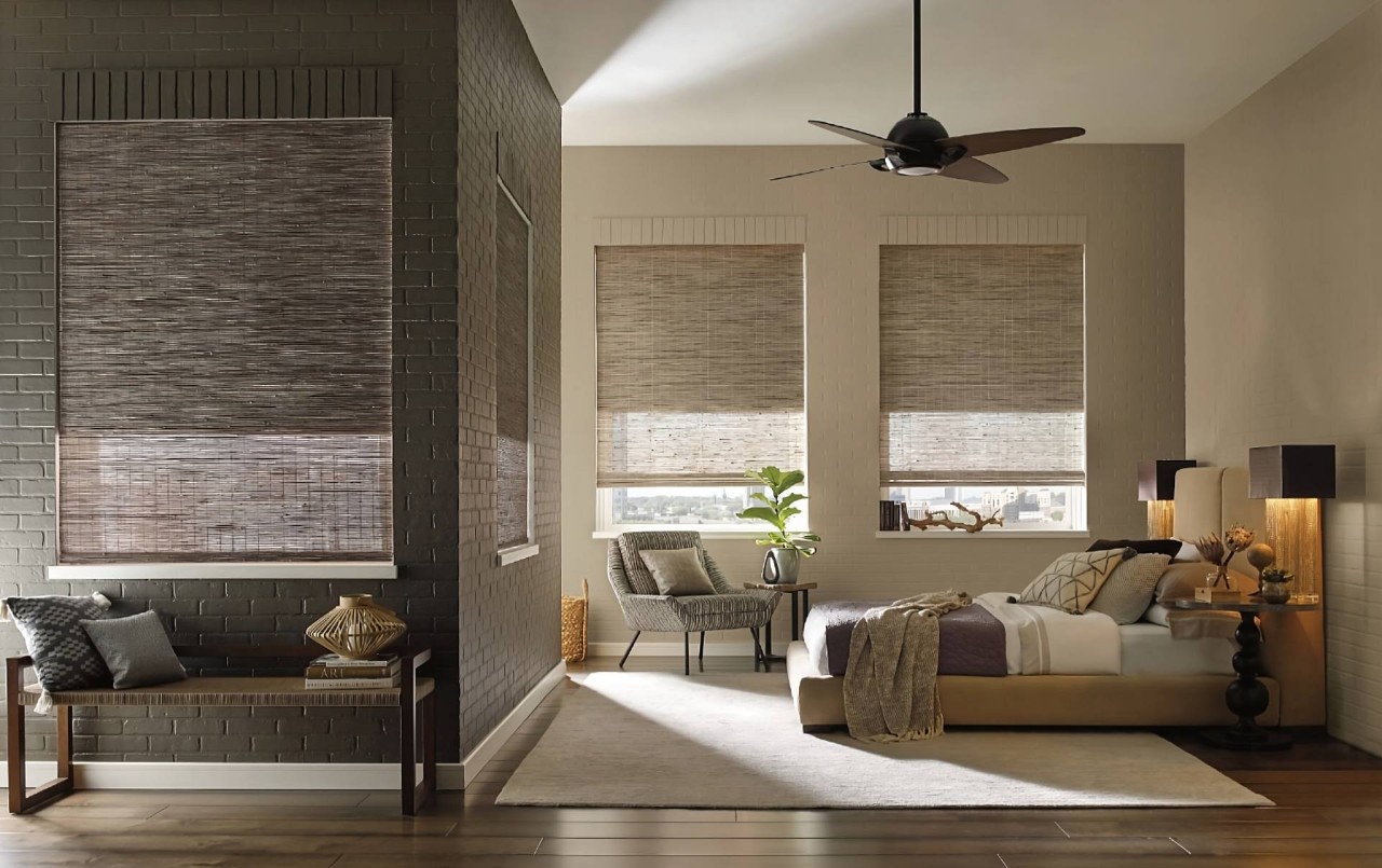 Provenance® Woven Wood Shades diffusing sunlight in a calming, chic bedroom with a neutral color palette at Custom Window Decor of Jupiter near Jupiter, FL