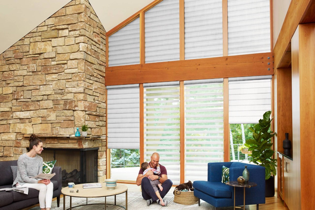 Pirouette® Sheer Shades for odd-shaped windows in a living room with a family spending time together near Jupiter, FL